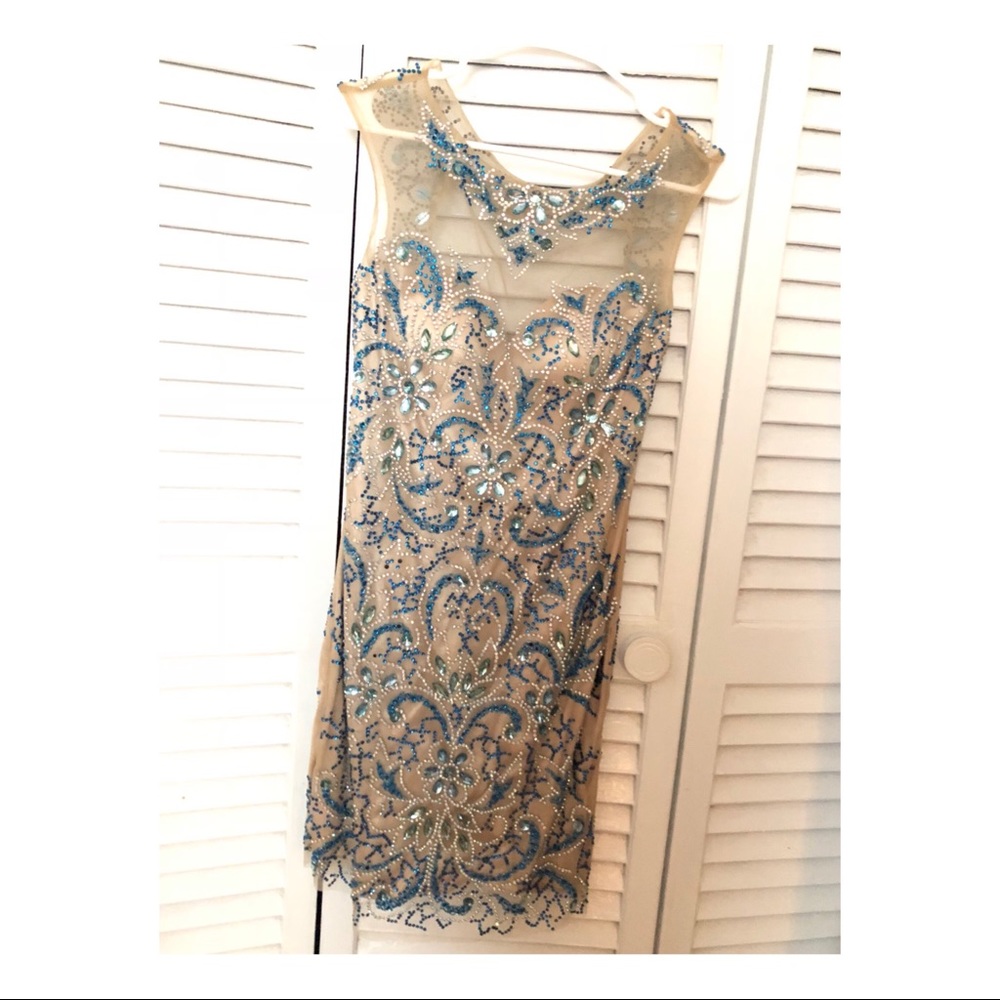 Nude dress with blue and silver stones and cut out back. Absolutely stunning!